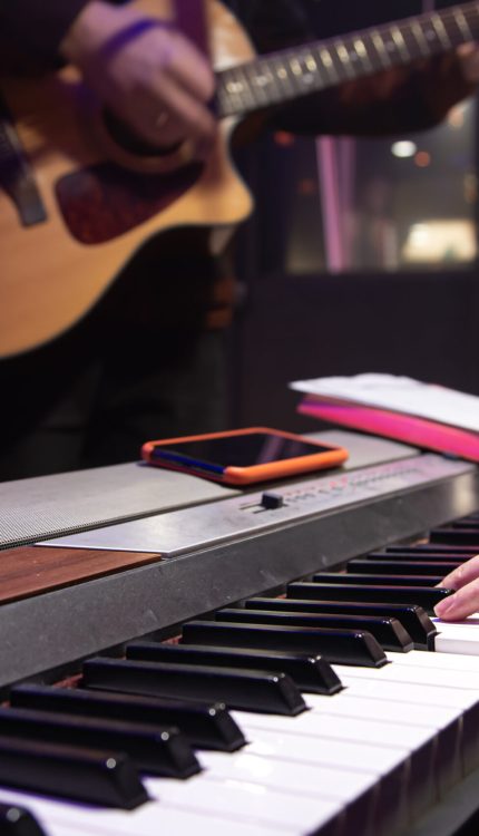 The pianist and guitarist are playing. Music recording or rehearsal concept.